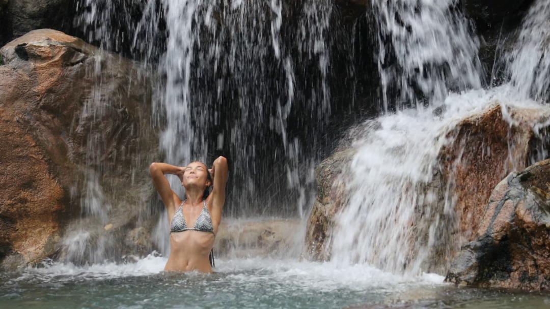 sexy-beautiful-multicultural-woman-bathing-and-swimming-under-waterfall-in--1536871663307.jpg