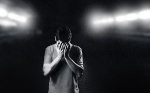 monochrome-photo-of-man-covering-his-face-1556716-300x186.jpg