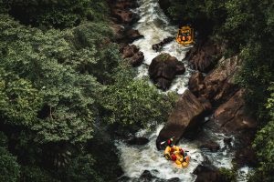 two boats white water rafting on river
